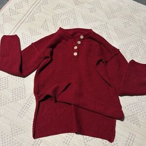 Red knit, 4 tan buttons.